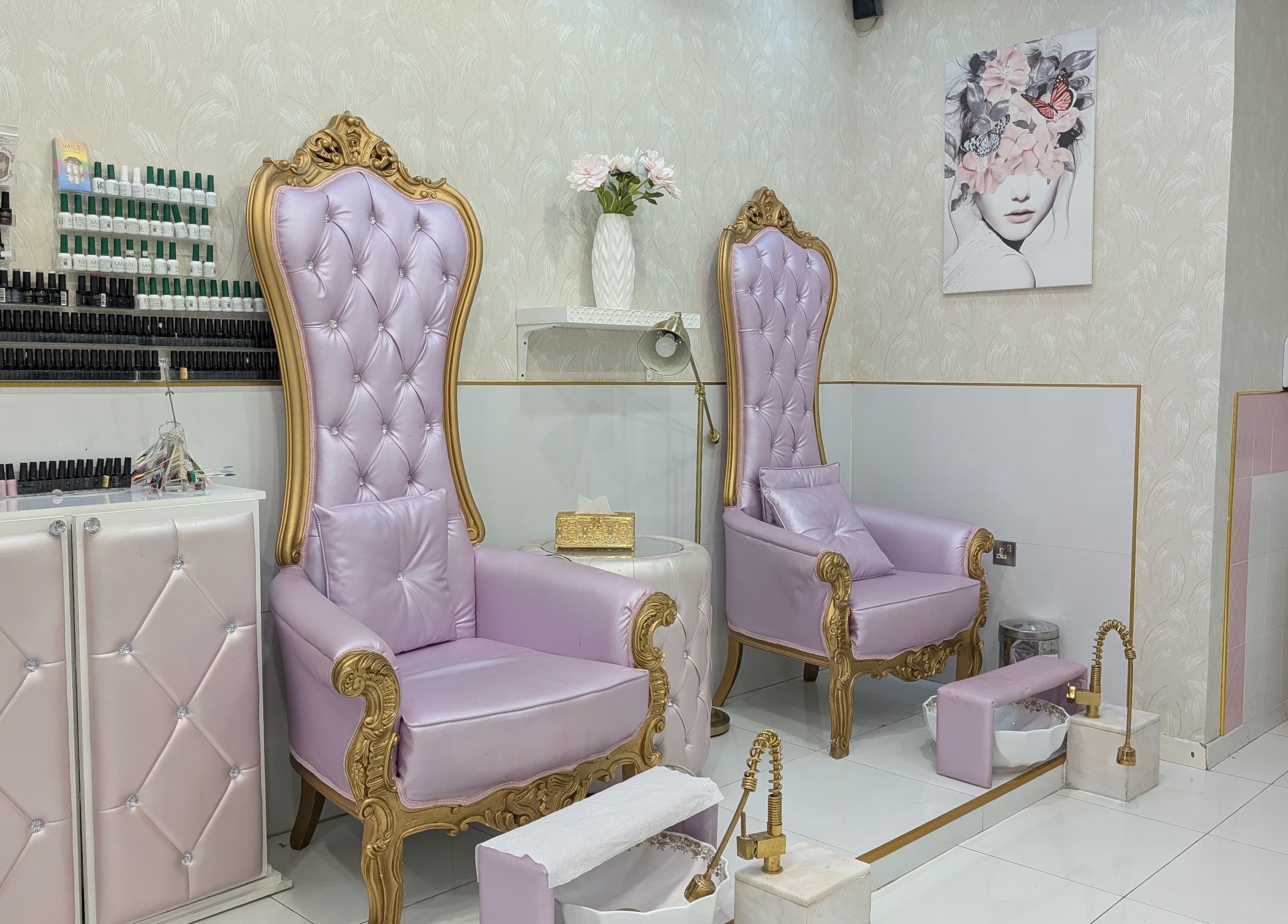 Luxurious purple chairs at Zulya Beauty Salon in Dubai, AE, showcasing elegance and comfort with gold accents.