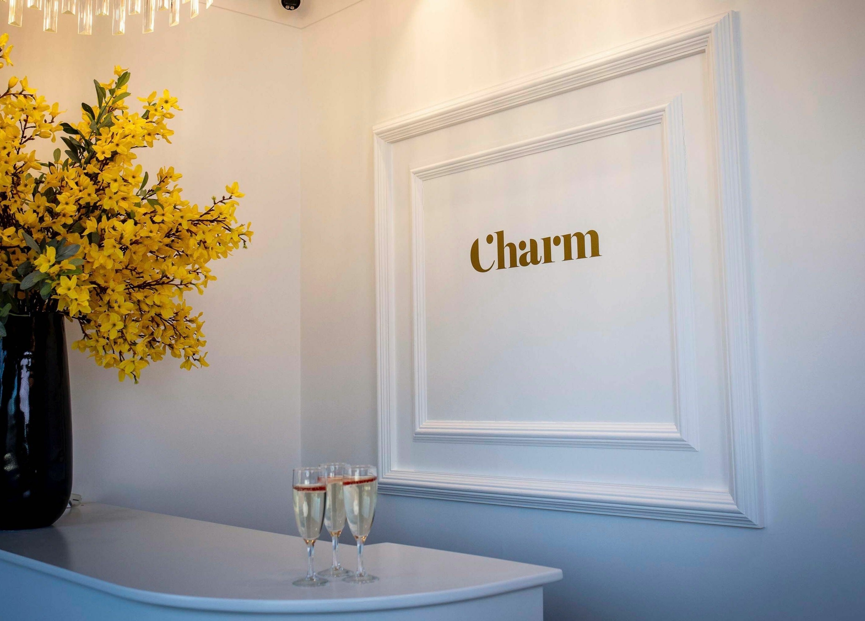 Bright flowers and charm sign at Charm Clontarf, Dublin, County Dublin, IE reception area.