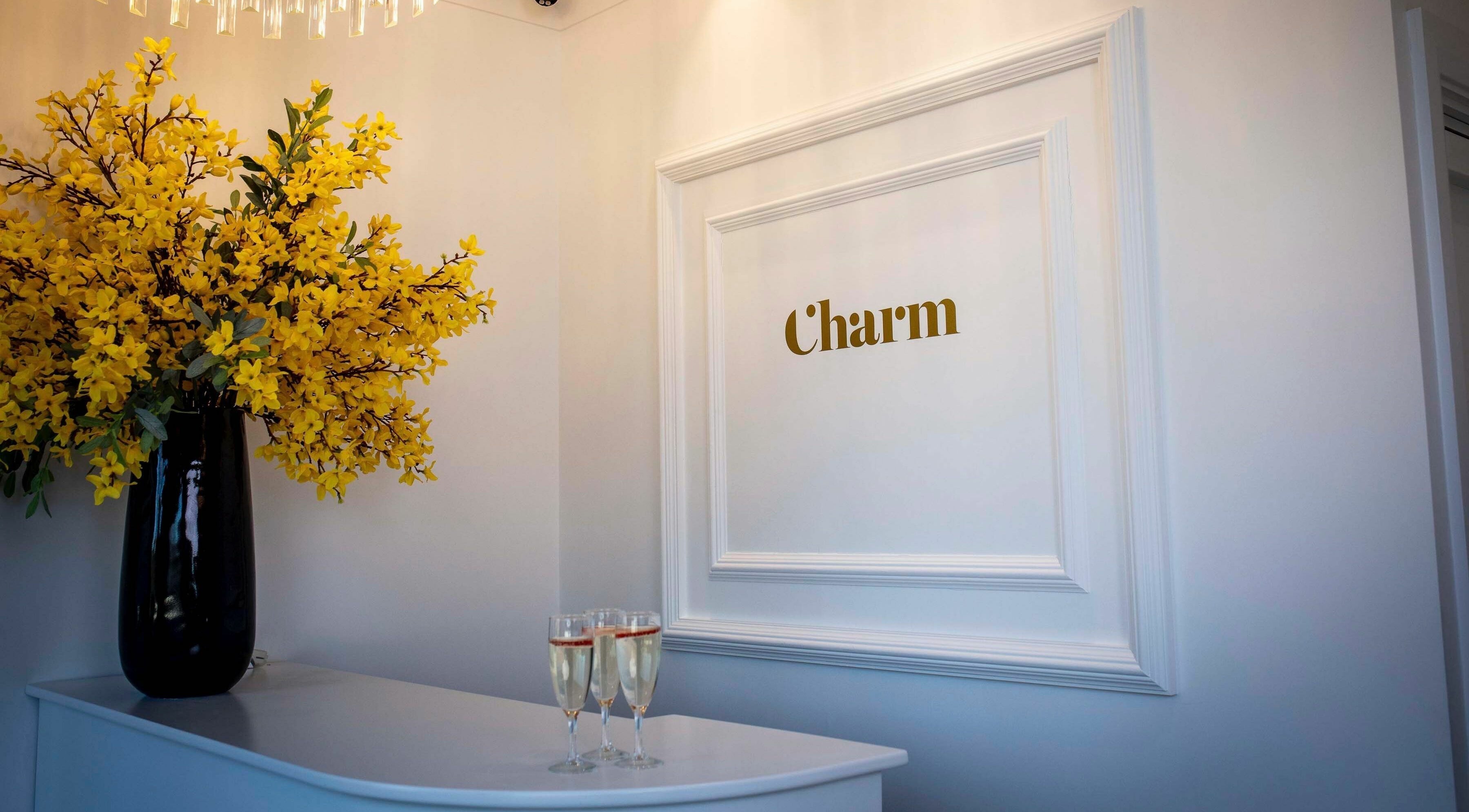 Bright flowers and charm sign at Charm Clontarf, Dublin, County Dublin, IE reception area.