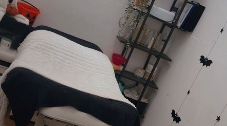 Relaxing treatment room at Poppys Lashes & Beauty, Exmouth, England, GB. Features comfortable bed and decor.