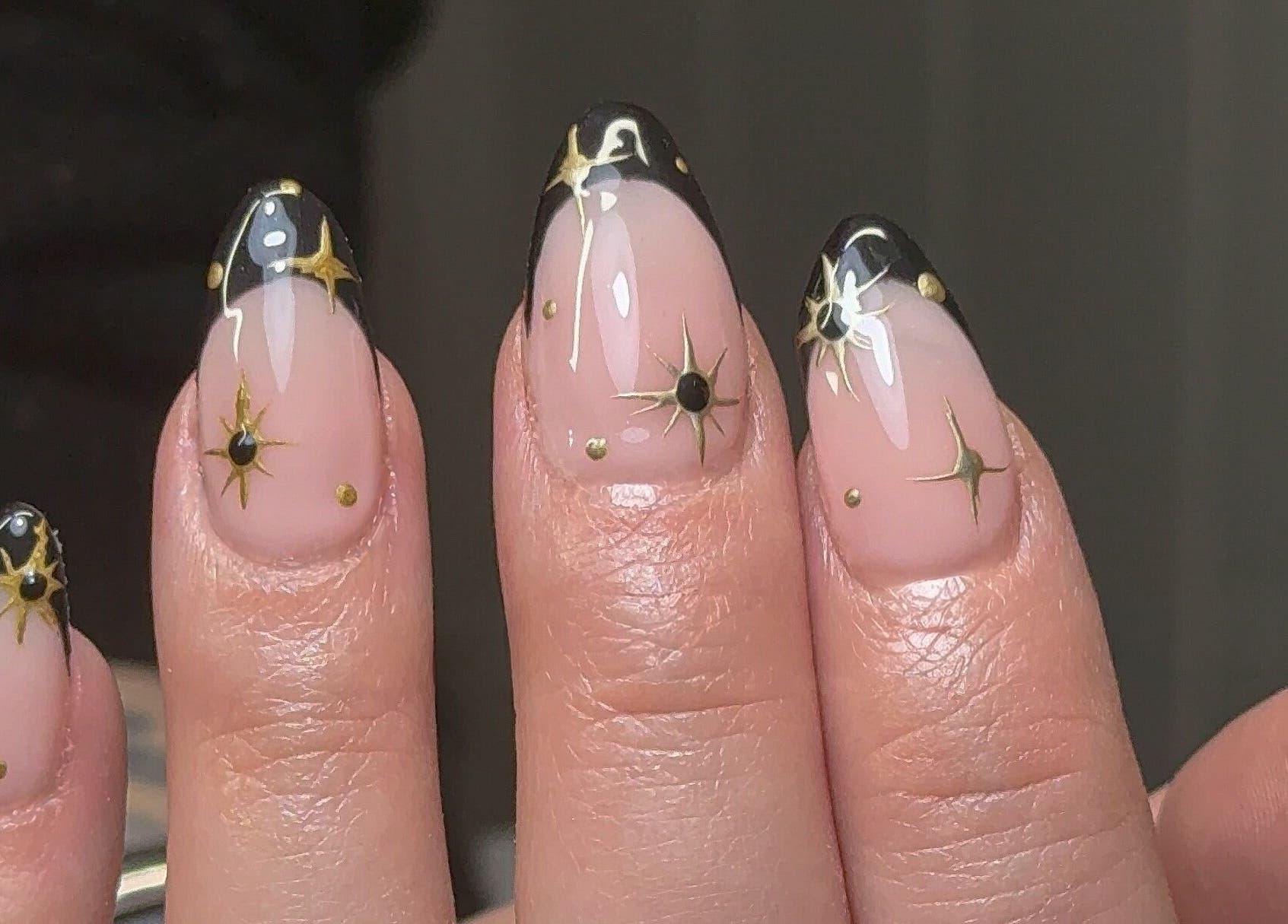 Elegant celestial nail art by Nailedbygeorgina in Queensbury, England, GB showcasing gold star accents.