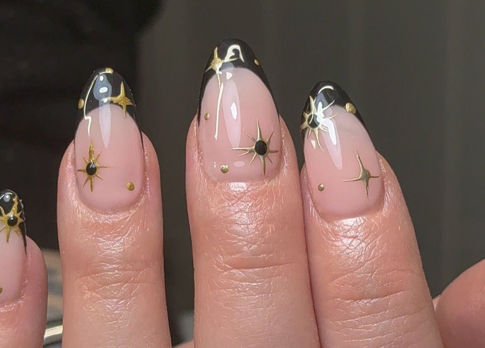 Elegant starlit nail design at Nailedbygeorgina, Queensbury, England, GB. Black tips with gold stars.
