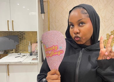 Client at Beauty With Raye holding a sparkling mirror in Bristol, England, GB salon.
