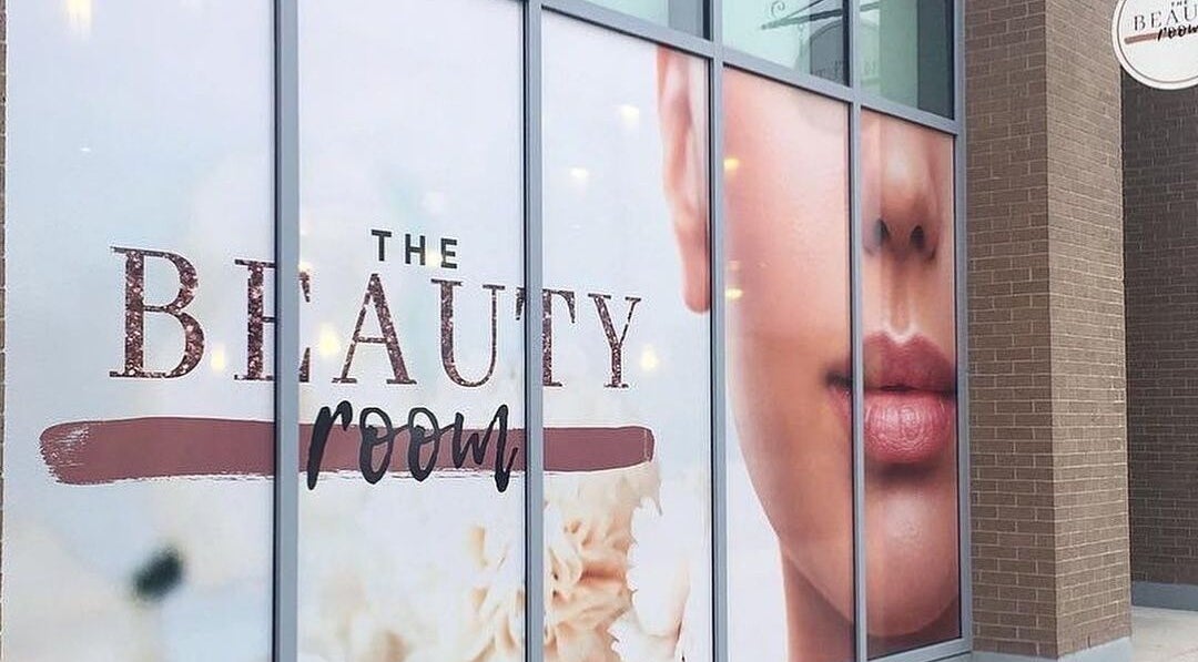 Entrance of The Beauty Room in Oshawa, Ontario, CA, featuring elegant signage on glass windows.