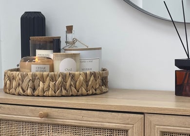 Elegant aroma setup at Mika Beauty, Wilmslow, England, GB with candles and a diffuser on a wooden table.