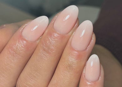 Close-up of glossy nude nails at Mika Beauty, Wilmslow, England, GB, showcasing expert manicure.
