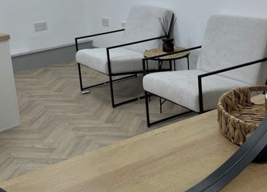 Chic waiting area at Mika Beauty, Wilmslow, England, GB with modern chairs and woven decor.