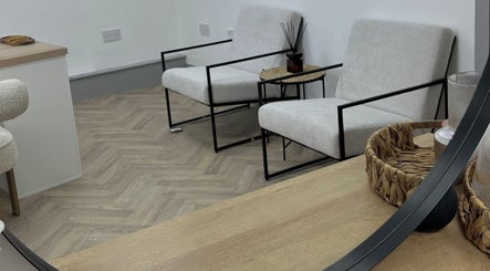 Chic waiting area at Mika Beauty, Wilmslow, England, GB with modern chairs and woven decor.