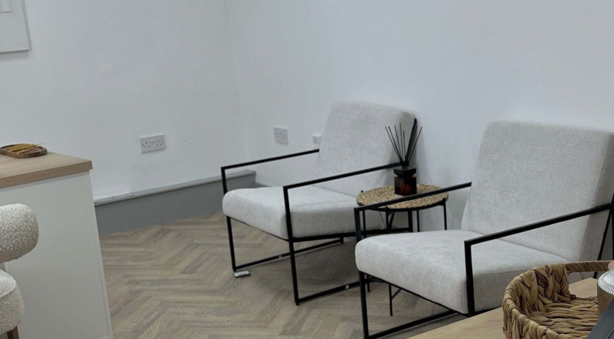 Elegant seating area in Mika Beauty, Wilmslow, England, GB with minimalist chairs and cozy decor.