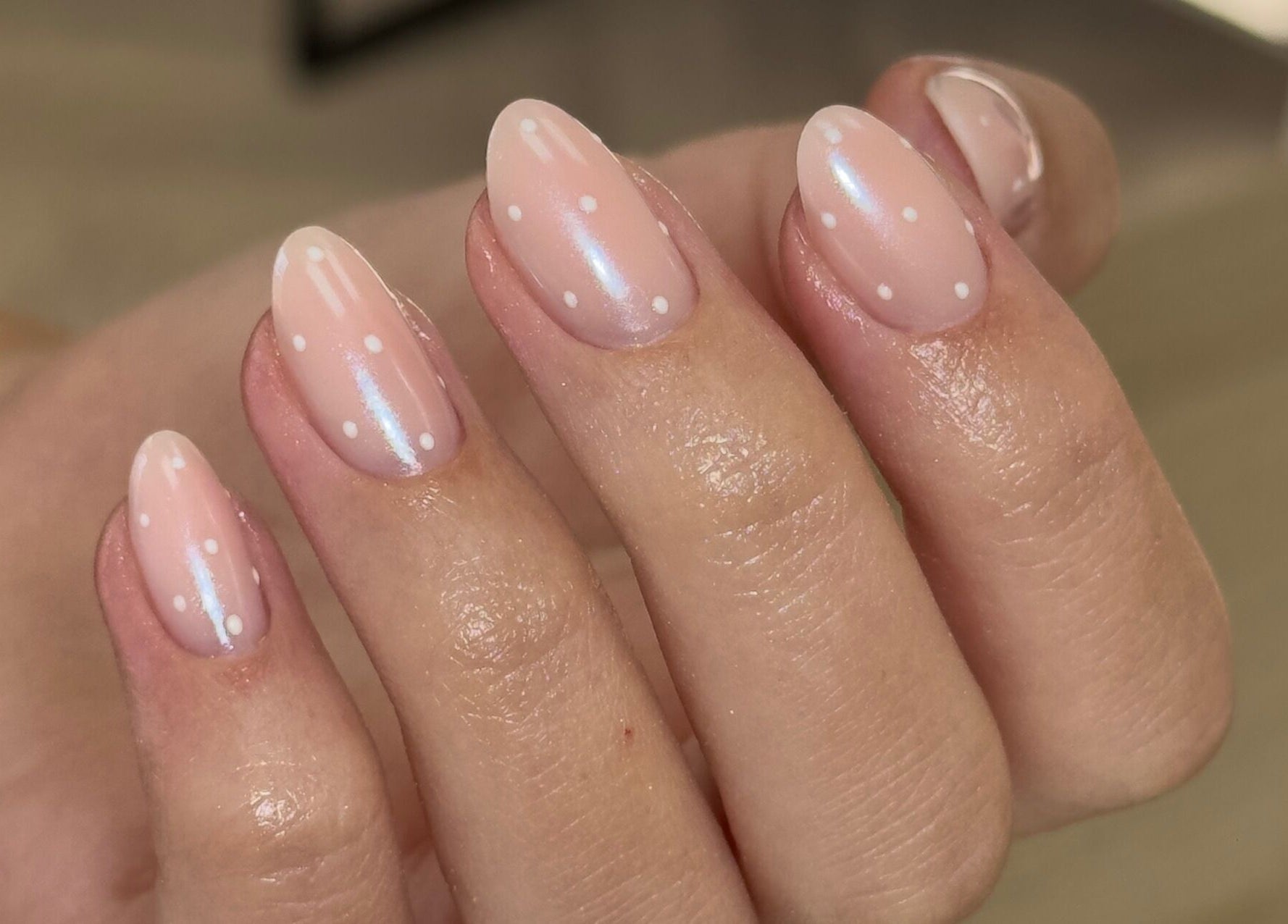 Elegant pink nails with white polka dots at Mika Beauty, Wilmslow, England, GB.