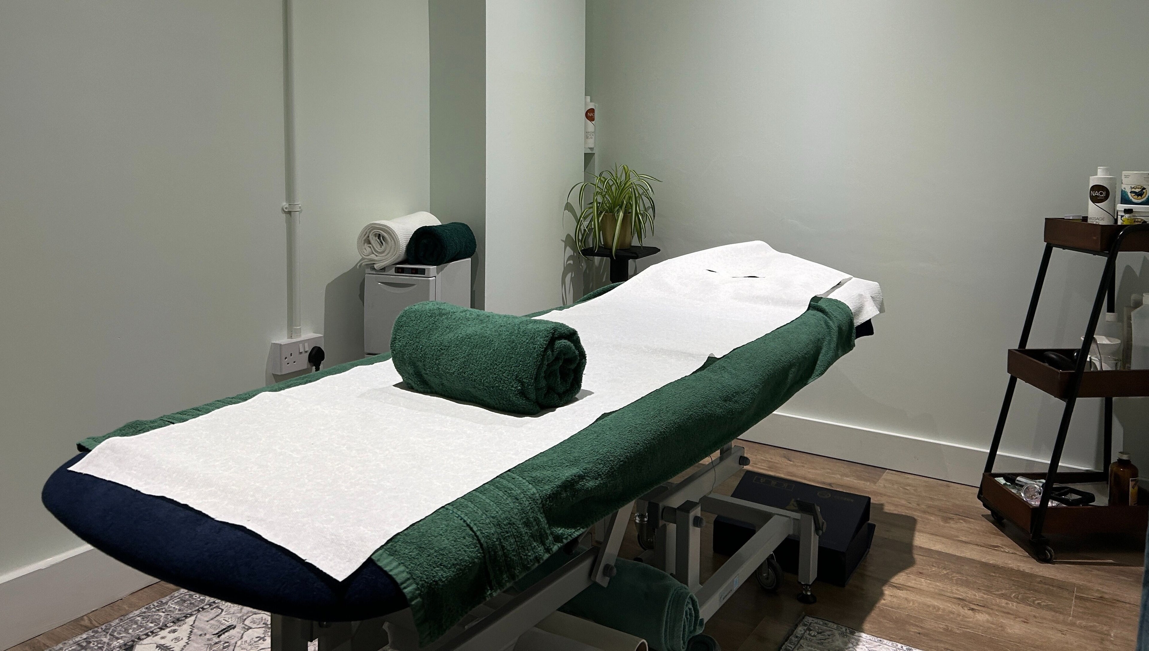Serene treatment room at Aramagen Holistic Clinic, Chester, England, GB with massage table ready.