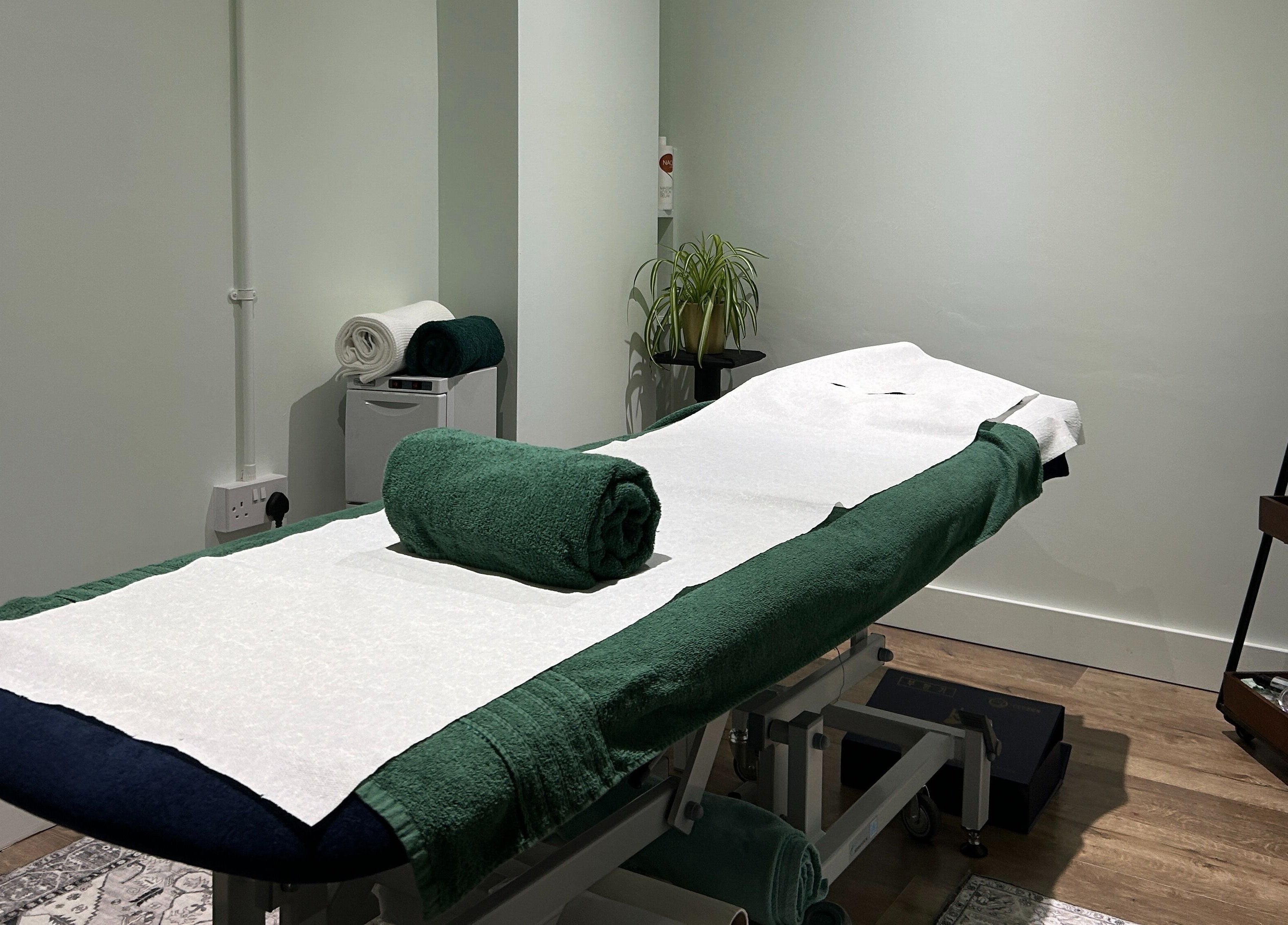 Serene treatment room at Aramagen Holistic Clinic, Chester, England, GB with massage table ready.