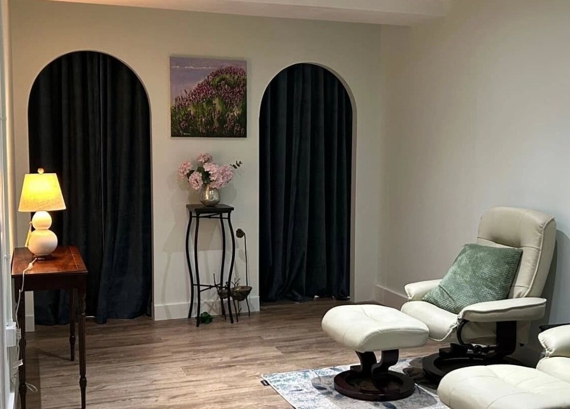 Cozy relaxation area at Aramagen Holistic Clinic, Chester, England, GB, featuring elegant chairs and soft lighting.