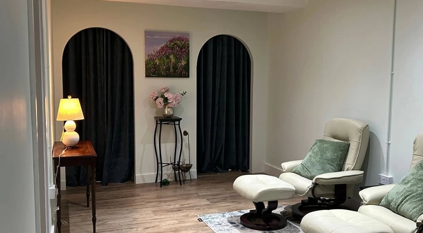 Cozy relaxation area at Aramagen Holistic Clinic, Chester, England, GB, featuring elegant chairs and soft lighting.