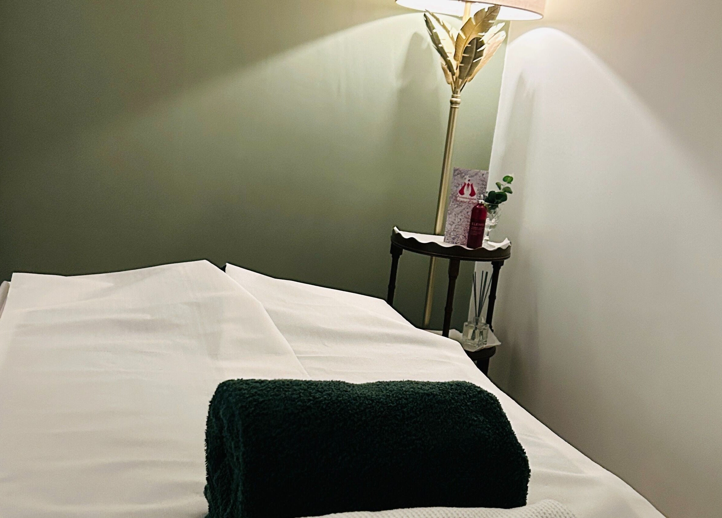 Tranquil therapy room at Aramagen Holistic Clinic, Chester, England, GB, featuring a neat table and soft lighting.