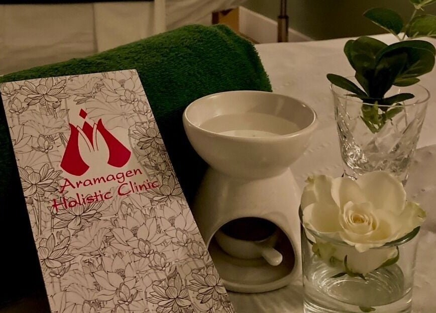 Relaxing setup at Aramagen Holistic Clinic with flowers and candle, Chester, England, GB.