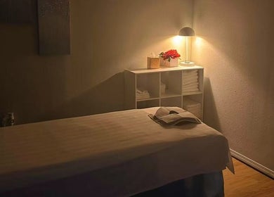 Serene massage room at Massage Relax & Spa in Springdale, Arkansas, US, featuring a softly lit therapy table.