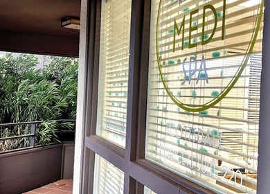 Window view at Bare Lacquer Scottsdale with lush greenery, Scottsdale, Arizona, US.