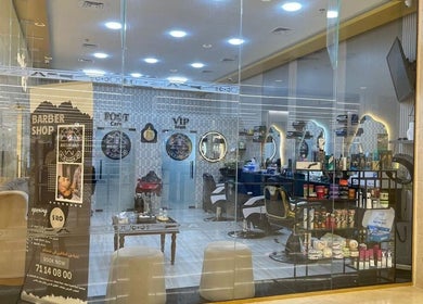 Modern interior view of Boulevard Salon By Hayssam, مسقط, محافظة مسقط, OM, featuring barber chairs and product display.