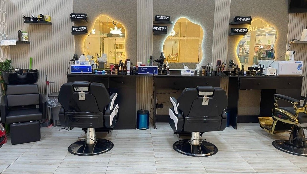 Stylish interior of Bayat Salon in مسقط, محافظة مسقط, OM, featuring modern barber chairs and mirrors.
