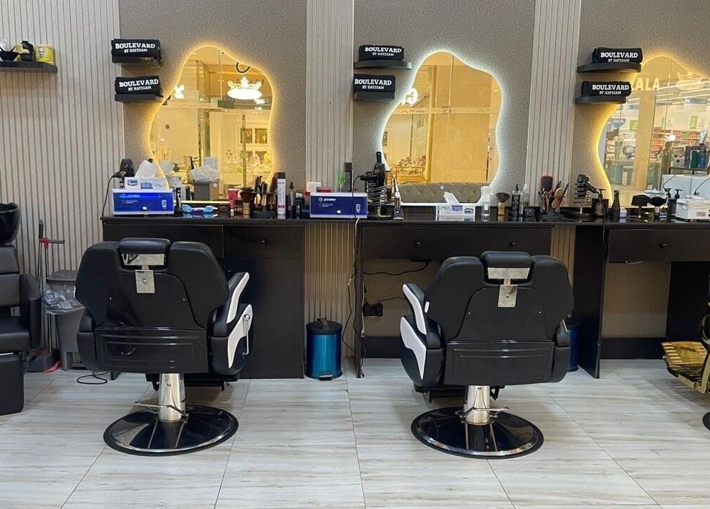 Stylish interior of Bayat Salon in مسقط, محافظة مسقط, OM, featuring modern barber chairs and mirrors.