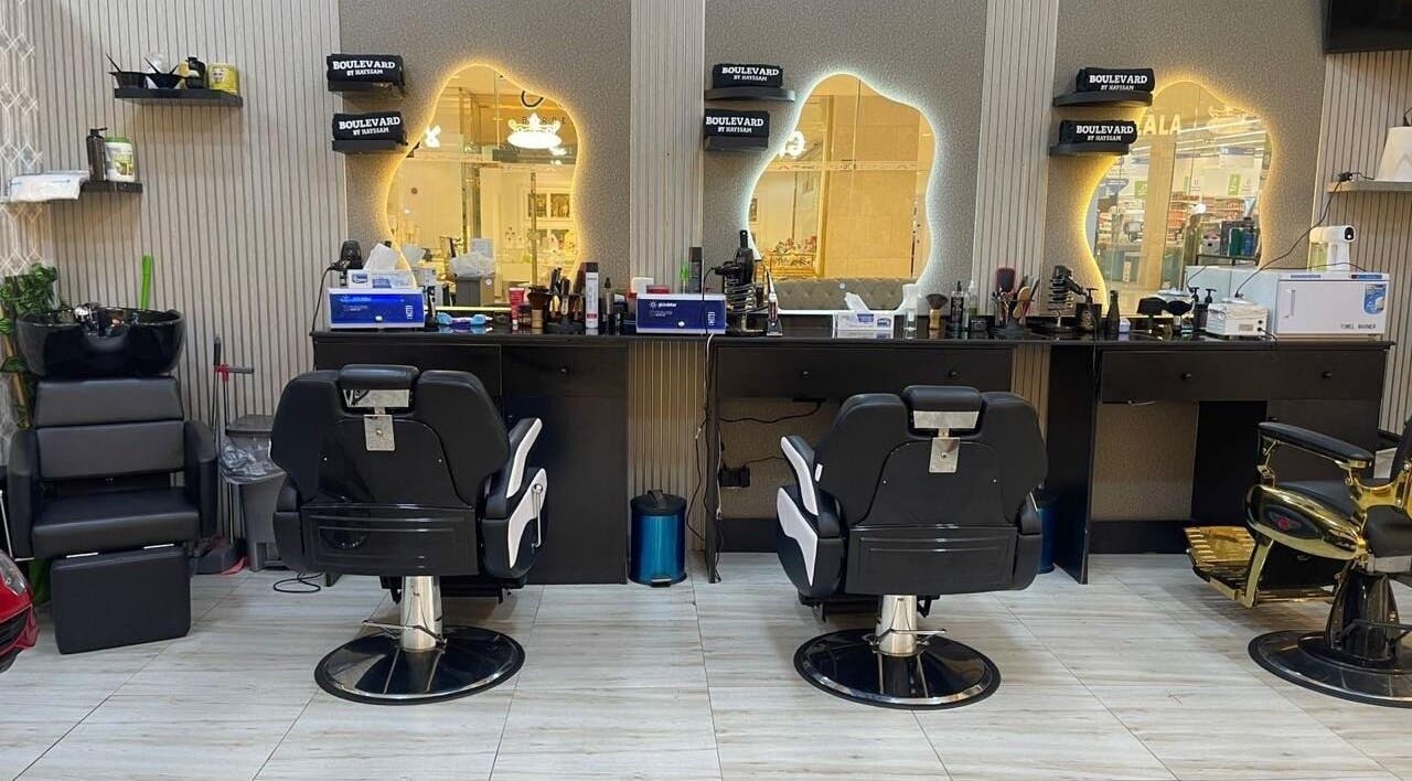 Stylish interior of Bayat Salon in مسقط, محافظة مسقط, OM, featuring modern barber chairs and mirrors.