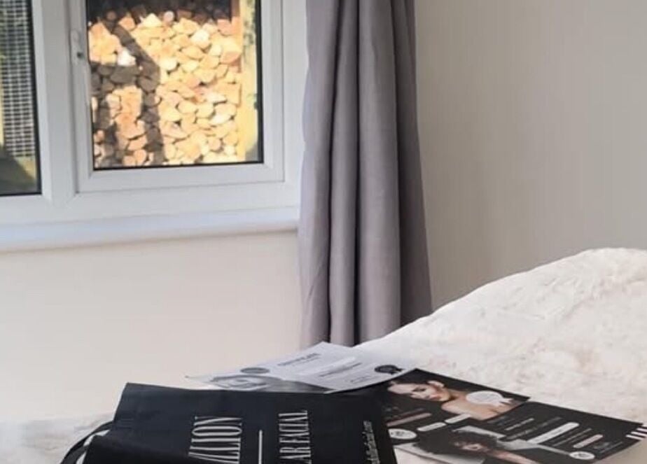 Relaxing treatment room at KEFI BEAUTY, Par, England, GB with sunlight filtering through window.