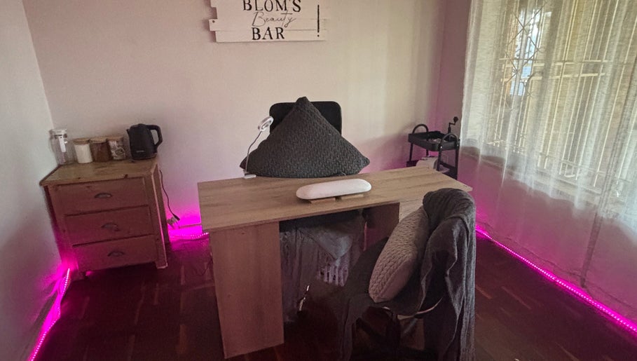 Chic setup at Blom's Beauty Bar, Boksburg, Gauteng, ZA. Elegant nail desk with soft lighting and cozy chair.