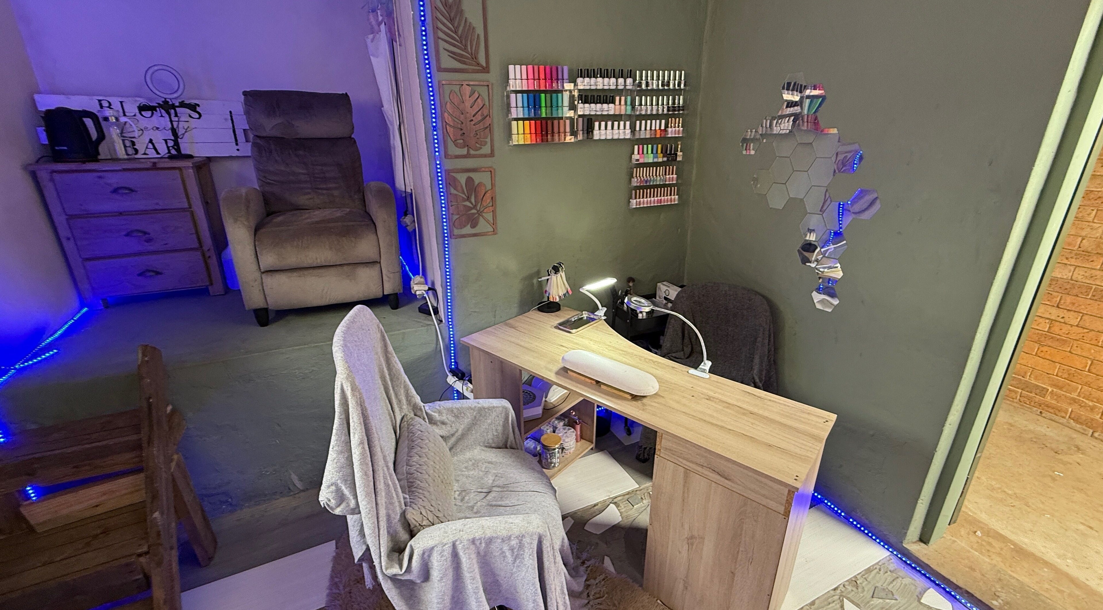 Cozy nail station setup at Blom's Beauty Bar, Boksburg, Gauteng, ZA with nail polish wall display.