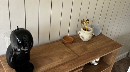 Elegant coffee setup at Mollys Nail Studio, Bridgend, Wales, GB with chic wooden decor.