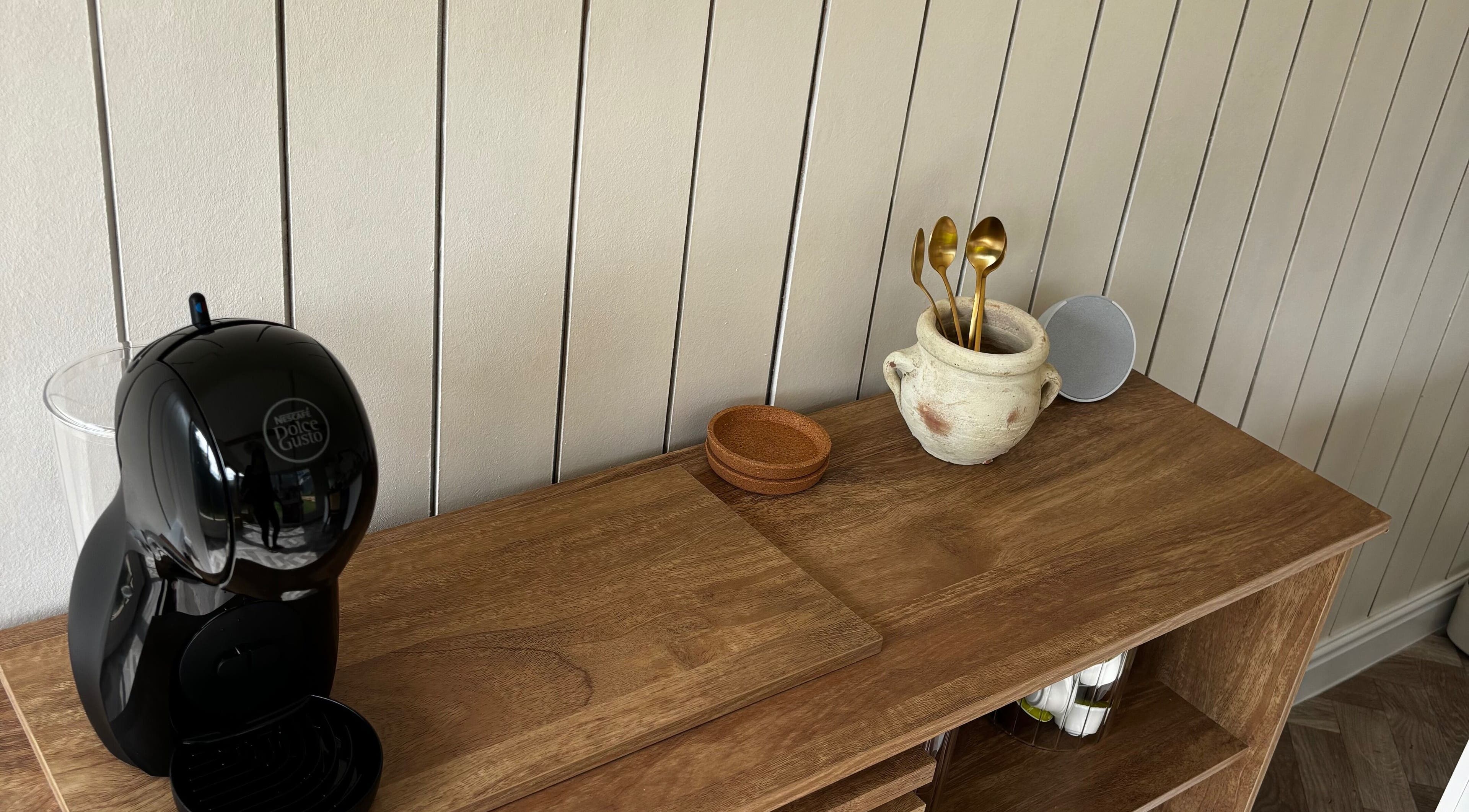Elegant coffee setup at Mollys Nail Studio, Bridgend, Wales, GB with chic wooden decor.