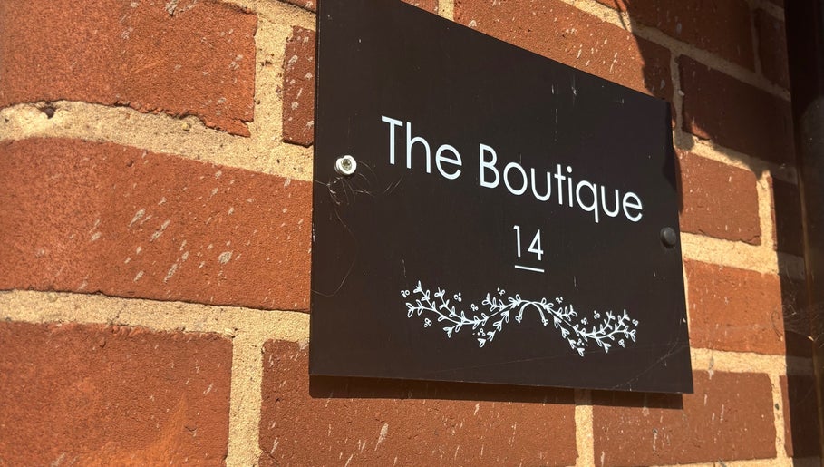 Elegant sign on brick wall at Hair By Hope, Knowle, England, GB.
