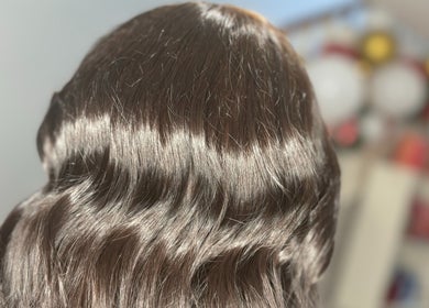 Shiny wavy hairstyle at Hair By Hope in Knowle, England, GB. Perfect salon styling with a smooth finish.
