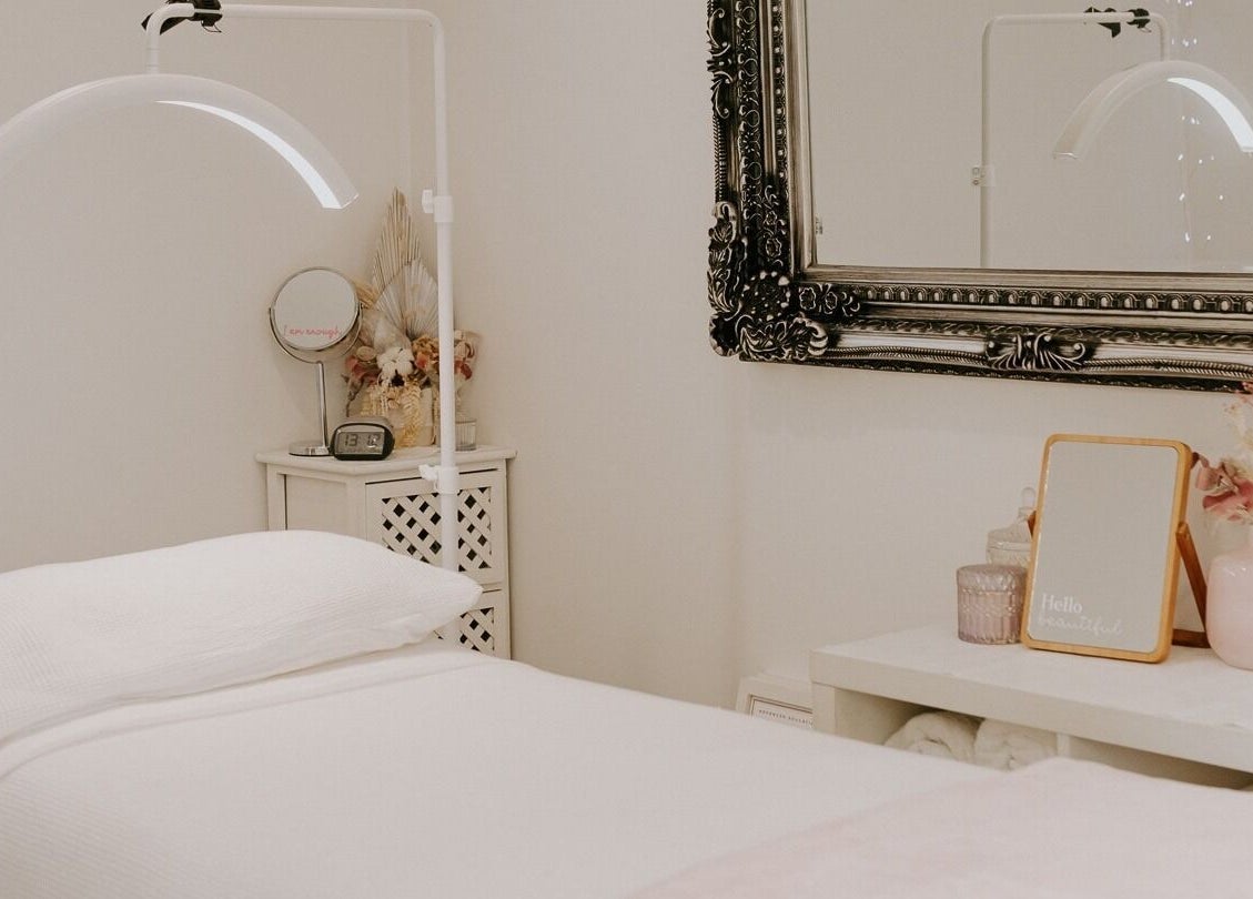 Cozy spa room at Fuchsia Beauty Therapy in Nelson, Nelson, NZ, featuring a luxurious treatment bed and elegant decor.