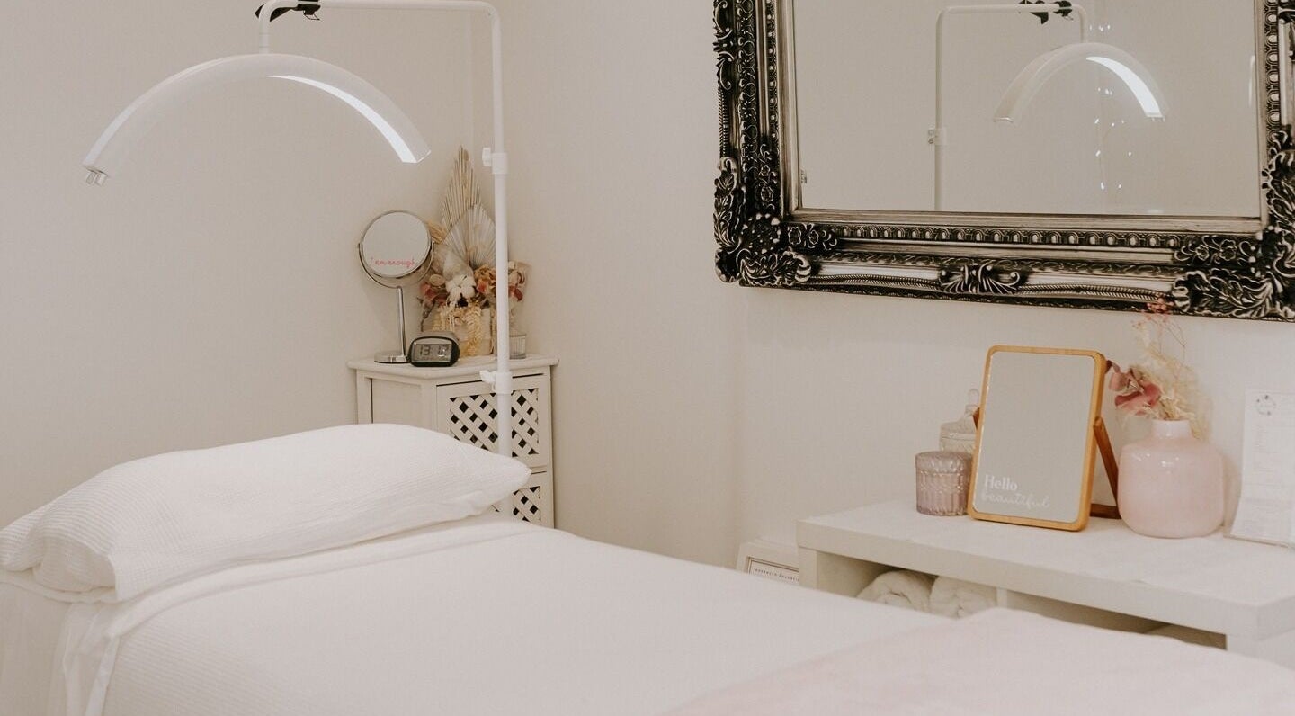 Cozy spa room at Fuchsia Beauty Therapy in Nelson, Nelson, NZ, featuring a luxurious treatment bed and elegant decor.