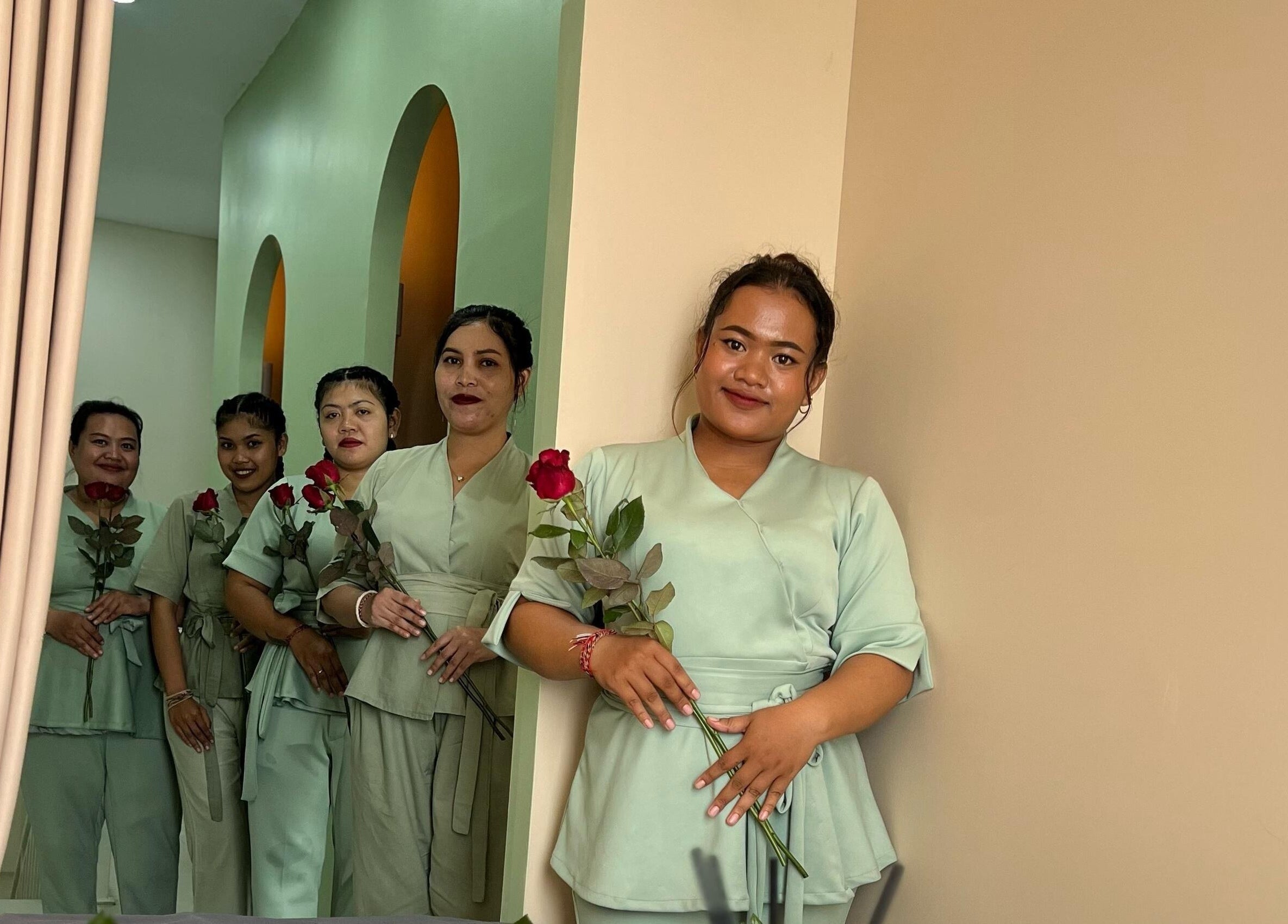 Smiling staff with roses at BeautyfulSpa, Bali, Bali, ID, ready to welcome guests warmly.