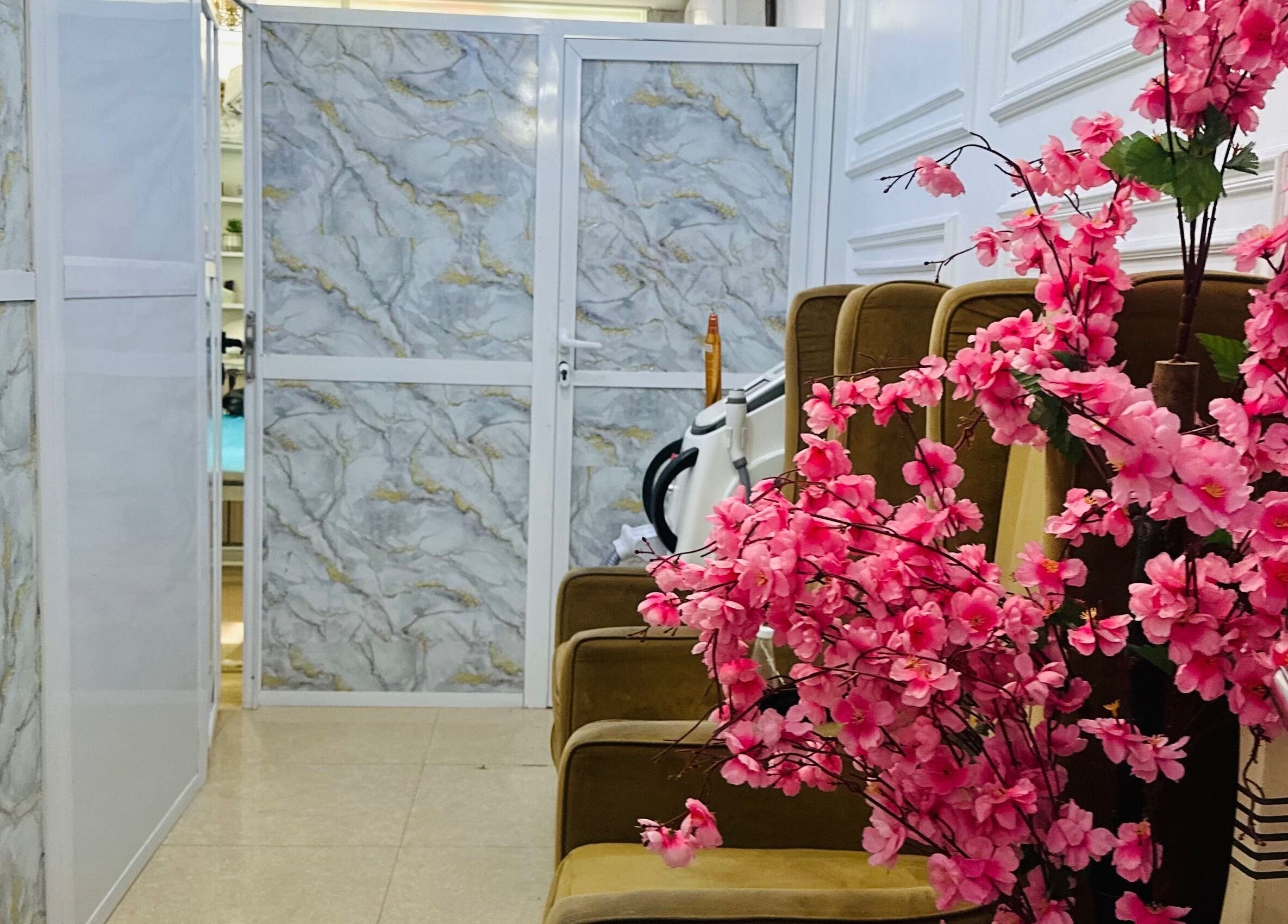 Elegant seating and pink flowers at ABT MED SPA, Lekki, Lagos, NG, offering a serene ambiance.