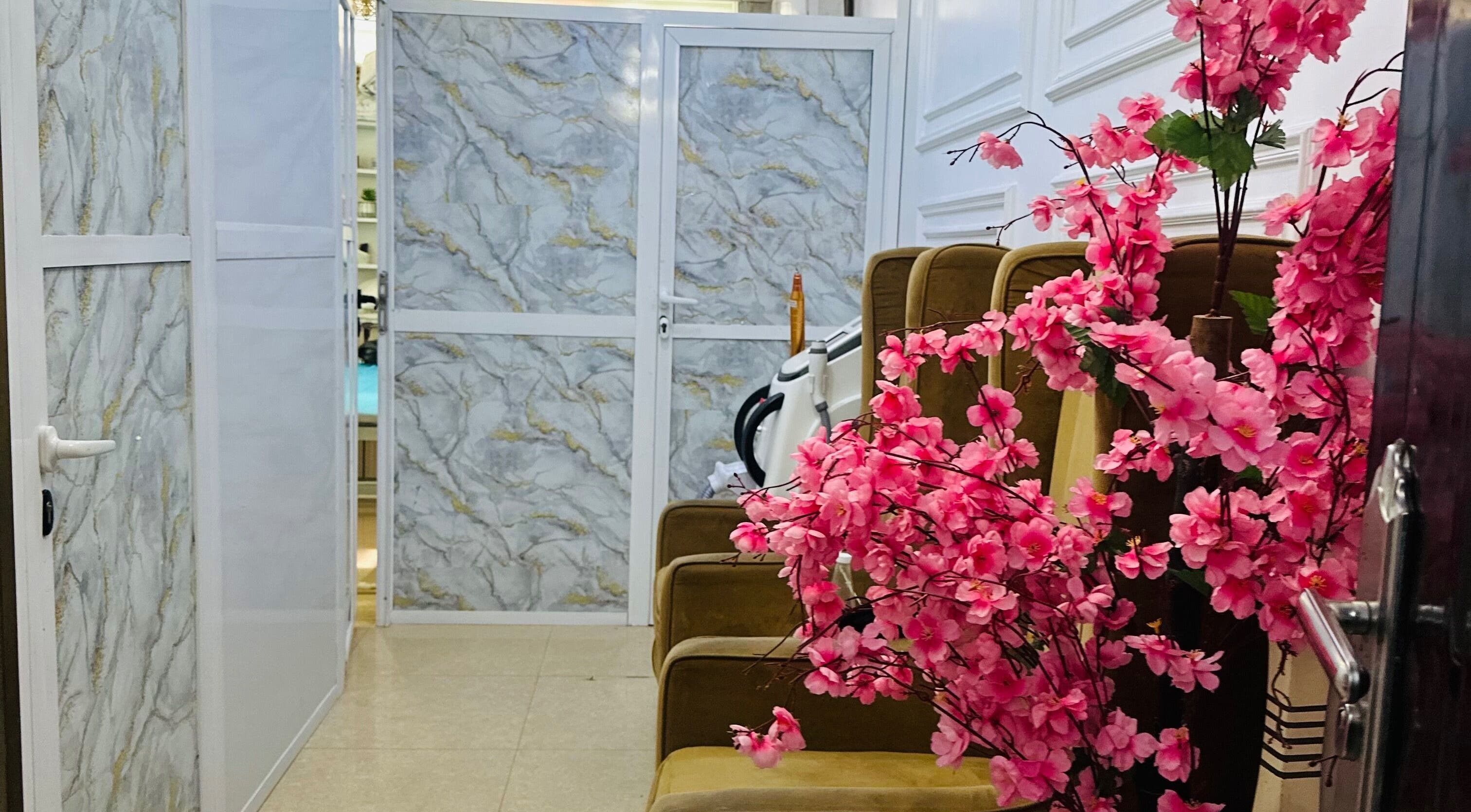 Elegant seating and pink flowers at ABT MED SPA, Lekki, Lagos, NG, offering a serene ambiance.