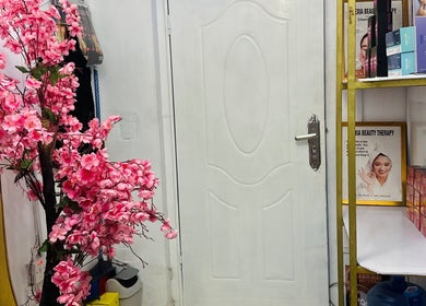 Elegant entrance with pink flowers at ABT MED SPA, Lekki, Lagos, NG, offering a serene welcome.