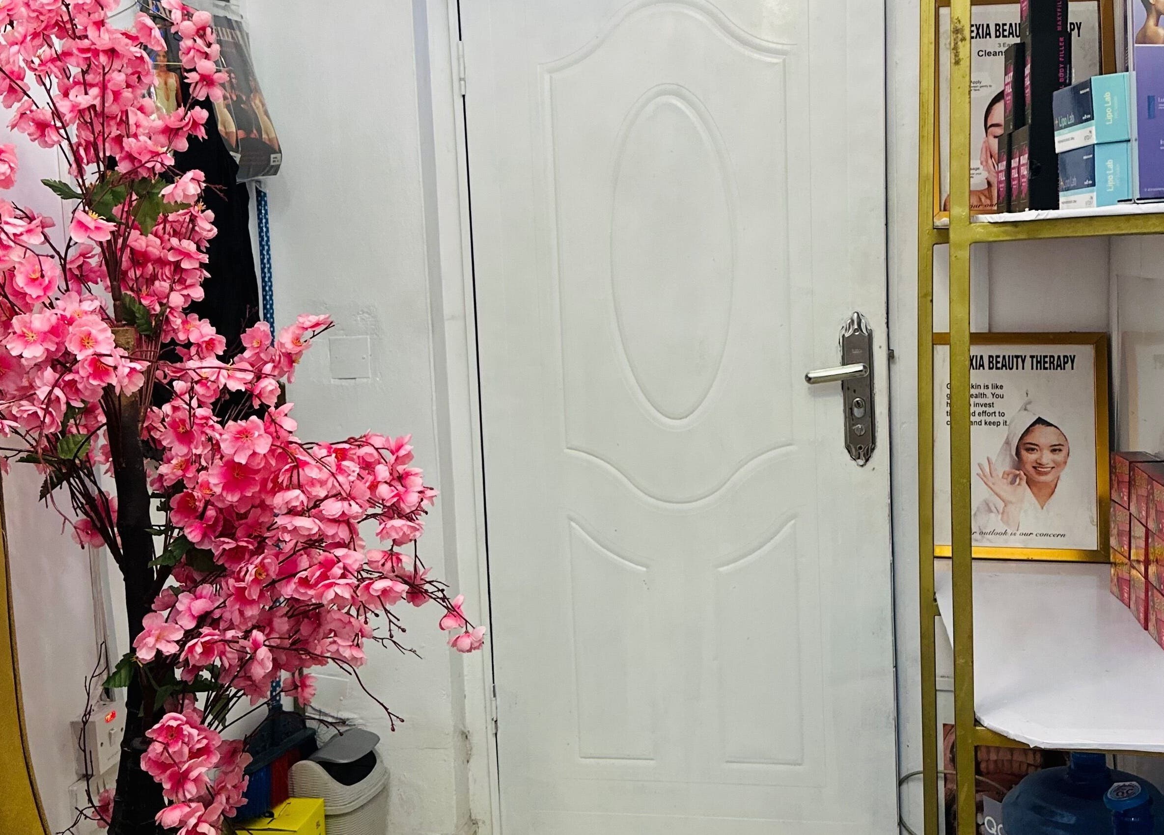 Elegant entrance with pink flowers at ABT MED SPA, Lekki, Lagos, NG, offering a serene welcome.
