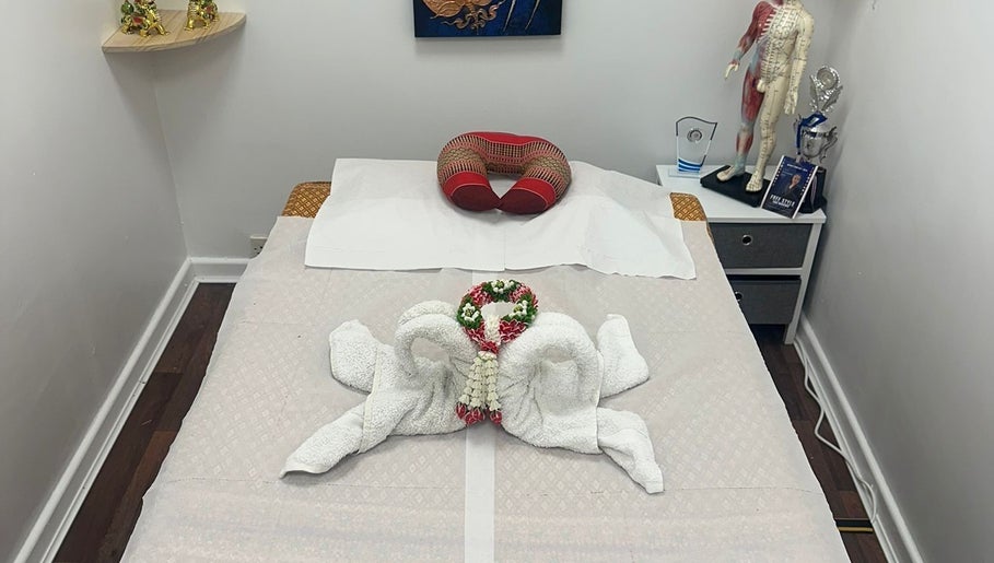 Massage bed at Hua Hin Moon Thai Massage in Sunderland, England, with elegant towel decor and relaxing ambiance.