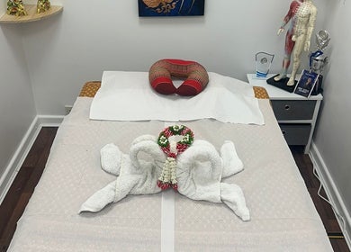 Massage bed at Hua Hin Moon Thai Massage in Sunderland, England, with elegant towel decor and relaxing ambiance.