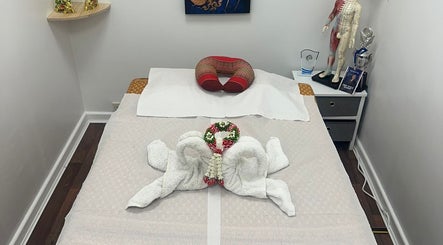 Massage bed at Hua Hin Moon Thai Massage in Sunderland, England, with elegant towel decor and relaxing ambiance.