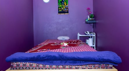 Peaceful massage room at Hua Hin Moon Thai Massage, Sunderland, England, GB, with vibrant purple decor.