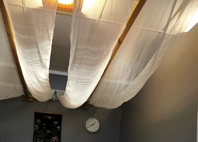 Hua Hin Moon Thai Massage tranquil room in Sunderland, England, GB with elegant ceiling drapes.