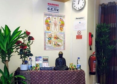 Reception area at Hua Hin Moon Thai Massage in Sunderland, England with plants and a Buddha statue.