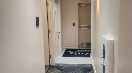 Entrance hallway of CHELLE HAIR DESIGN in Boca Raton, Florida, US, featuring stylish decor and lighting.