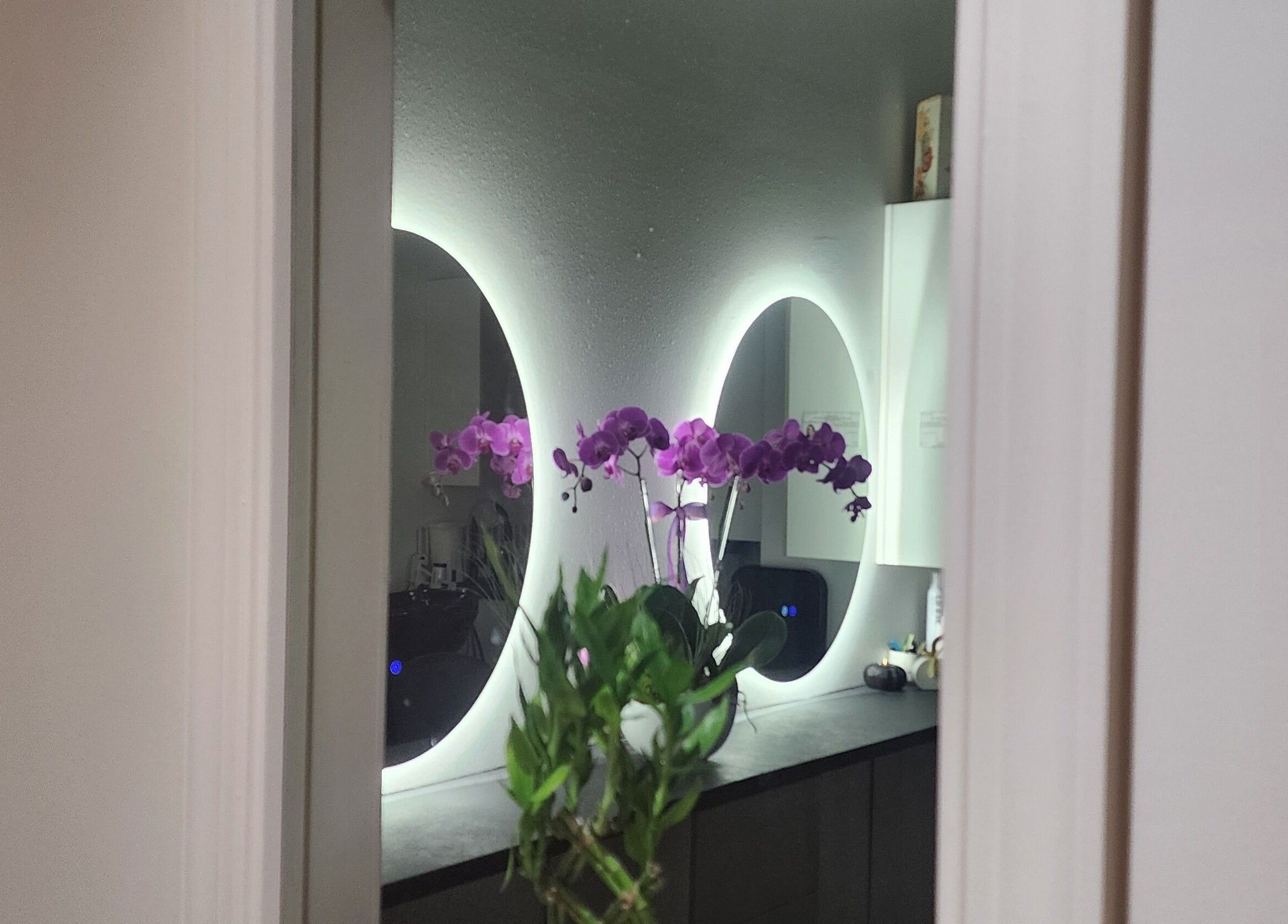 Elegant mirrors and orchids at CHELLE HAIR DESIGN in Boca Raton, Florida, US creating a serene atmosphere.