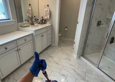 Pristine bathroom cleaned by Maid To Sparkle in Rochdale, England, GB, showcasing spotless tiles and organized vanity.