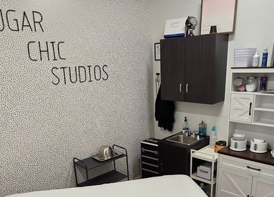 Interior of Sugar Chic Studios in Idaho Falls, Idaho, US showcasing modern treatment room with stylish decor.
